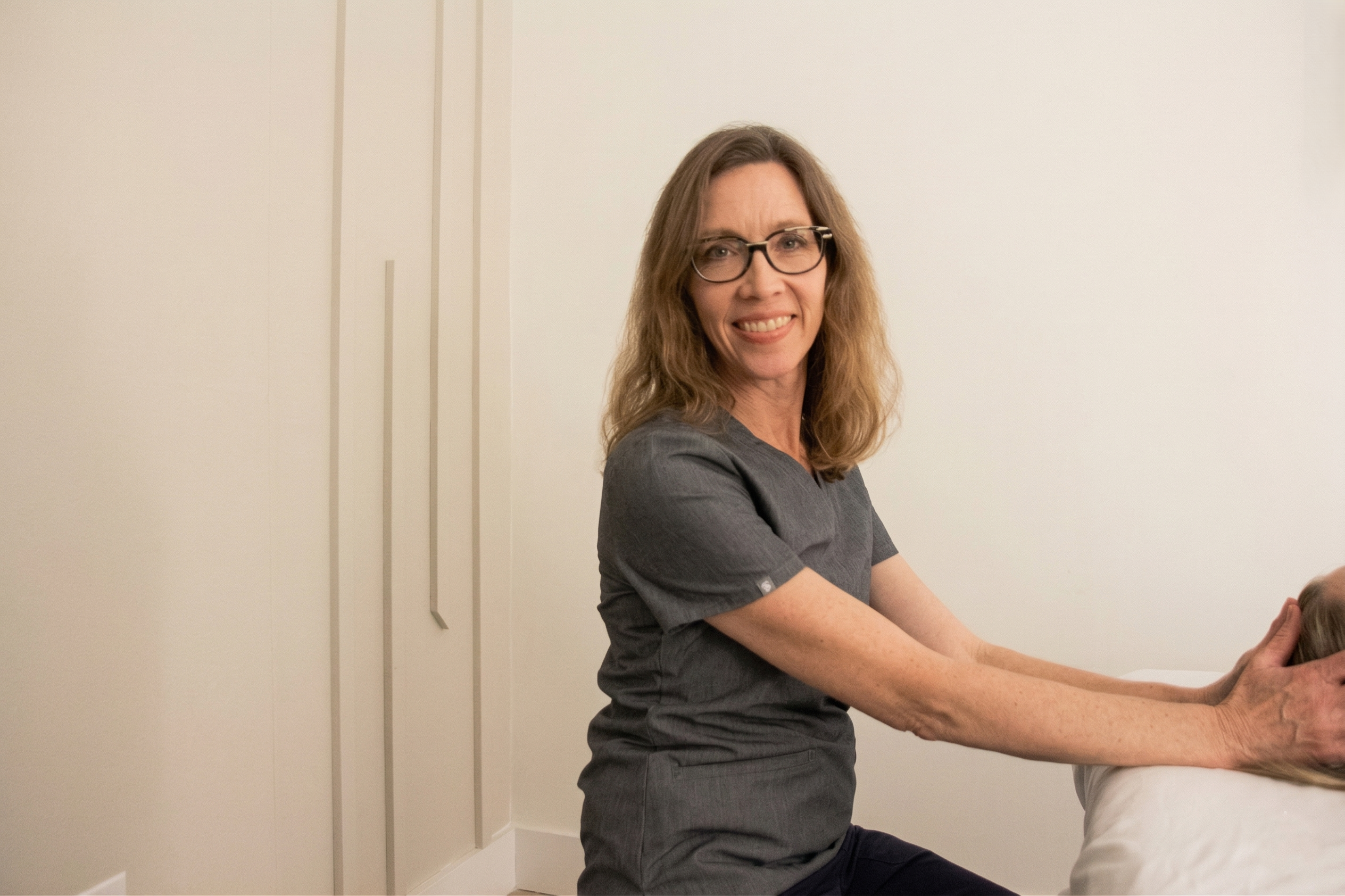 Amy performing CranioSacral Therapy on a client